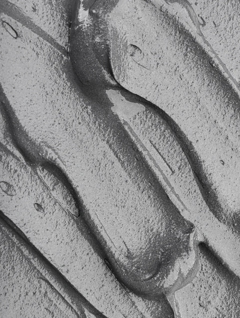 Close-up of hydrating skincare gel texture, targeting dryness, with botanical actives in clear smear.